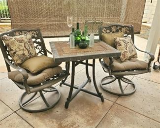 Stone top patio table with 2 swivel chairs, vintage green bottles