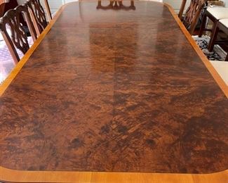 Custom flame-mahogany saddalwood banded dining room table. As shown, table measures 70" W x 46" W x 30" H. Extends to 149" with 5 leaves. Photo 1 of 2.
