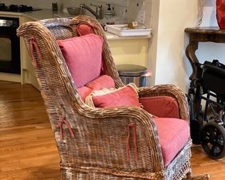 Wicker rocking chair with raspberry cushions. Photo 2 of 2.