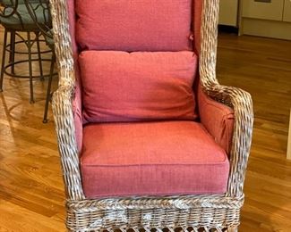 Wicker rocking chair with raspberry cushions. Photo 1 of 2.