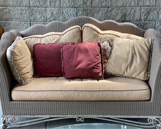 All-weather woven wicker settee.