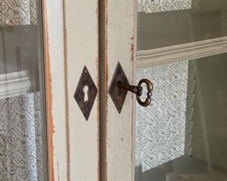 Antique glass front cabinet with wallpaper interior and skeleton key. Measures 57" W x 17" D x 80" H. Photo 3 of 3.