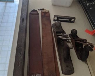 Old antique wood making planes, knife sharpening belts, plus solid metal antique levels (mini plus large)