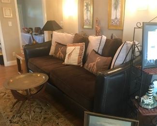 Black and brown faux leather & microfiber sofa $250