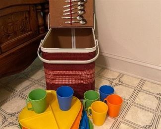 Vintage picnic basket with serving pieces. 