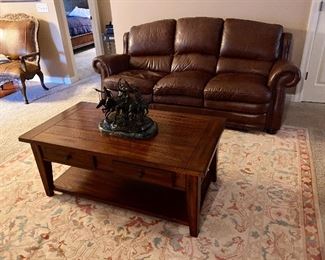 Leather sofa, coffee table, area rug, Bronze Sculpture