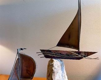 LOT #142 - $50 - Lot of 2 Metal Sailboat Sculptures Mounted on Rocks (lot includes both, the smaller is signed Demott, the larger is unsigned)