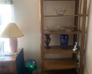 Oak bookcase w it’s crystal vases and small desk with lamp