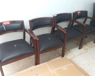 4 wooden chairs with black seat cushion and back rest