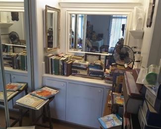 Books Display over the Bathroom Sink Area. Small 3 Feet Half Circle Wood Table and Books.