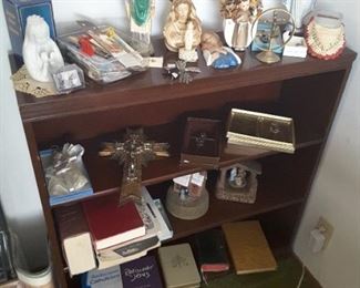 Close-up of Religious Collectibles, Statues, Bibles on a 3-Tiered Book Shelf with one flat upper ledge. Shelf is good for Collectibles or as a Book Shelf.
