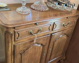 This fruitwood cabinet coordinates with the buffet.