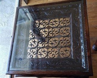 Ornate Wood Side Table with Glass Top. Measures approximately 24" H x 24" W x 24" D
