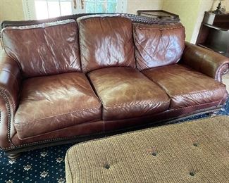 Leather sofa by Henredon with nailhead detail:  (39' x 96" x 47") $800, ottoman (18" x 53" x 30") $150, 