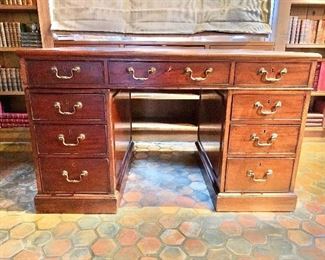 $1,495 - 1870's fine nine drawer wood desk with leather top and brass handles. Wear consistent with age and use. 29.5"H x 49"W x 29"D (opening 23.5"H x 19.75"W)