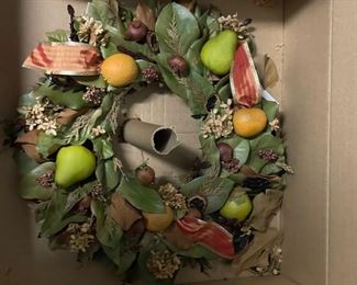 Faux fruit and greens wreath. 
