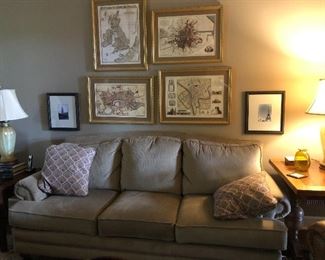 BEAUTIFUL LAZYBOY SOFA WITH MAP PRINTS ABOVE AND FRAMED PHOTOS