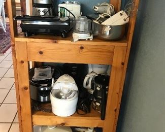 Small kitchen appliances and rolling wooden shelf