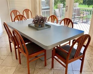 $375 - Light gray laminate table. 29.5"H x 72"W x 42"D; $600 all chairs - Two arm chairs (36"H x 20.5"W x 17.5"D (seat height 18"H) and six side chairs (36"H x 18"W x 17.5"D (seat height 18"H).  Wear consistent with age and use.