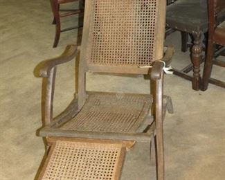 ANTIQUE CANED LOUNGER.