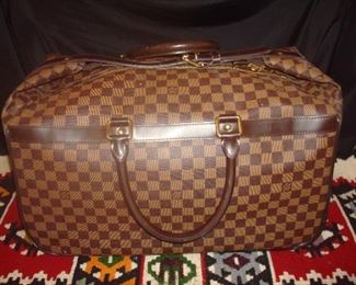 Louis Vuitton carry bag or wheeled with pull out handle.