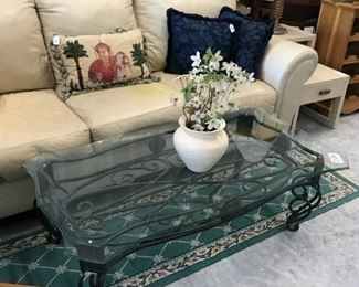 Glass coffee table w/iron base measures 4' x 28" x 16". $75, genuine leather sofa by Ashley has stain on the center cushion that I've been unable to remove. Sold as is. Otherwise, it's in great shape. $125