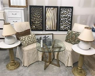 Glass table $75, 2 round lamps $40, 2 damask print chairs $100, white chest (behind) $30, Set of 3 metallic animal prints $120, round pedestal tables $20 each.