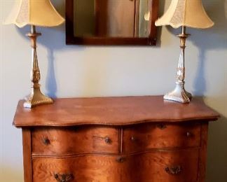 Curved front antique four drawer chest, antique mirror & lamps