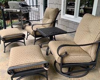Patio furniture: swivel rocker, chair, ottomans with all-weather cushions, and one side table