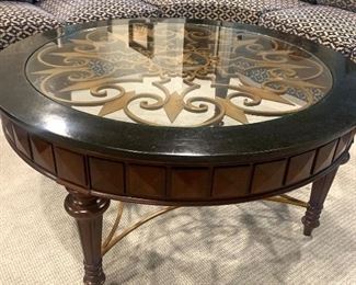 interesting 45” round coffee table with decorative brass accents