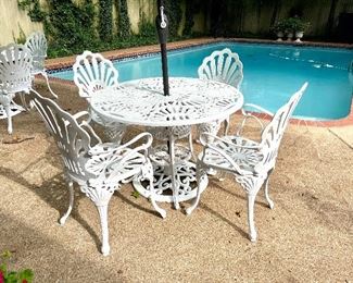 SOLD $450; 2 of these sets available! Set of 7 pieces, 4 wrought iron chairs with wrought iron table and umbrella stand, umbrella included; chairs 23.5w x 21d x 37h; table 41d x 28h; 8’ umbrella