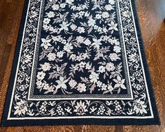 $80; black, floral hooked rug; 3.5’ x 5’; rug #8