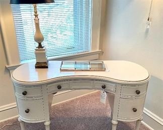 $160; Vintage desk with brass, floral pulls, four drawers and middle drawer; 48w x 20d x 30h;         $120; antique porcelain and brass table lamp with brass accents; 30”d x 29”h
