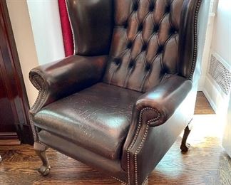 $600; leather wing-back chair with tufting and claw feet; 32”w x 32”d x 44”h