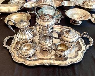 $250; silver-plate, 9-piece, tea service with exquisite detail; tray 32”w x 19”d