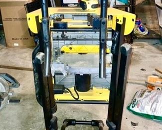 Dewalt table saw with folding stand on wheels, back view