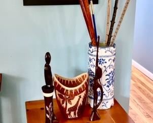 End table, carved collectibles, umbrella stand, misc. canes/walking sticks