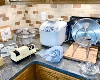 Oster bread maker, knife sharpener, misc. glass bowls, reamer, etc.