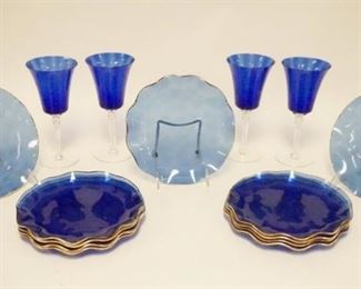 1039	15 PIECE COBALT BLUE BLOWN GLASS, 4 GOBLETS W/OPTIC RIB PATTERN & CLEAR STEMS, 8 1/4 IN HIGH & 11 RUFFLED PLATES W/GOLD RIMS, 8 1/4 IN DIAMETER

