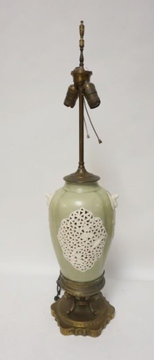 1152	POTTERY LAMP ON BRASS BASE, HAS OPEN WORK SIDES & FIGURAL HANDLES, 34 IN HIGH
