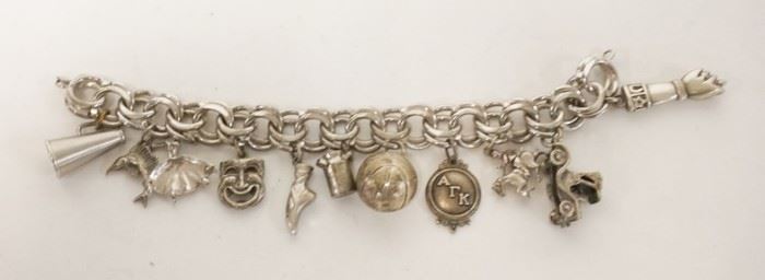 1168	STERLING SILVER CHARM BRACELET, FIST CHARM MARKED 800 WITH AN ANCHOR, MILK CAN AND MEDALLION MARKED STERLING, 8 OTHER CHARMS NO MARKING FOUND. 7 IN LONG, 2.55 TOZ
