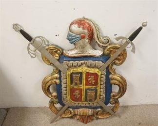 1309	CARVED WOODEN COAT OF ARMS, PAINTED, SWORDS ARE METAL, 34 IN HIGH X 35 IN WIDE
