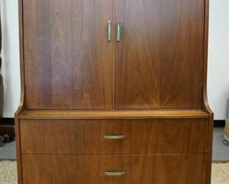 1350	KROEHLER MID CENTURY MODERN STEP BACK CABINET, HAS TWO DRAWERS BENEATH, INTERIOR DRAWERS & SHELVES ALSO HAS AN ELECTRICIAL OUTLET. 38 IN W 63 IN H. HAS SCRATCHES IN THE FINISH ON ONE SIDE

