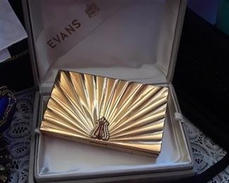 As beautiful closed as open. One side is a cigarette holder, one side with cosmetic and coin compartments. In original box.