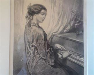 Framed print of a young woman at a piano