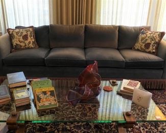 96" blue velvet sofa, mid century glass and burnished gold metal coffee table.