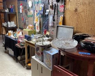 TV trays, metal cabinet, baking tins, crystal bowls, pots and pans, utensils