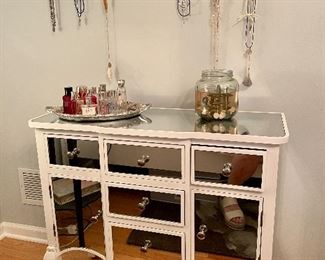 This beautiful wooden console cabinet with mirrored doors, drawers and surface will add that smash of panache to your bedroom or living room! This cabinet not only offers ample storage, but enhances the decor as well. 