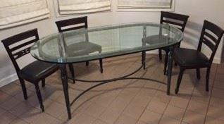 Here is a glass-top table along with four chairs.