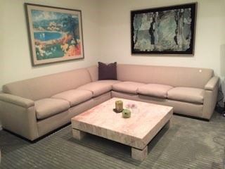 Another sectional sofa, coffee table, and framed artwork can be seen here.